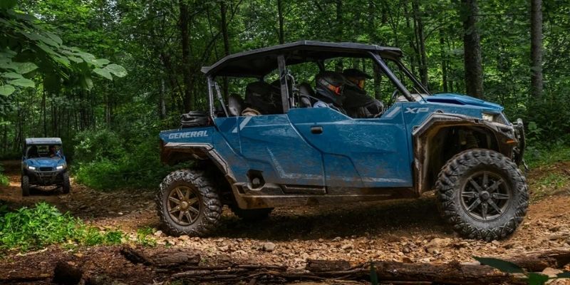 2026 Polaris GENERAL on a pine trail with cargo