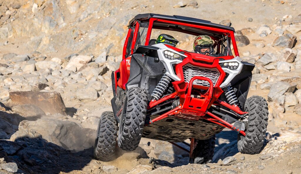 Red Honda Talon sport side-by-side on a rocky climb